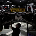 Article thumbnail: An engineer works below a Land Rover Defender mild hybrid electric vehicle at the new Jaguar Land Rover electric vehicle test centre in Whitley, Britain, October 23, 2023. REUTERS/Phil Noble