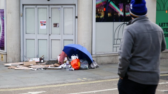 Article thumbnail: LONDON, UNITED KINGDOM - 2023/11/30: A man looks at the belongings of a homeless person who sleeps on the pavement in central London. Emergency accommodation will be set for London's rough sleepers as the Mayor of London has implemented severe weather protocol in London amid freezing weather in the coming days. (Photo by Steve Taylor/SOPA Images/LightRocket via Getty Images)