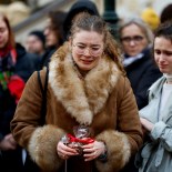 Article thumbnail: A woman reacts at a memorial during a vigil following a shooting at one of Charles University's buildings in Prague, Czech Republic, December 22, 2023. REUTERS/David W Cerny