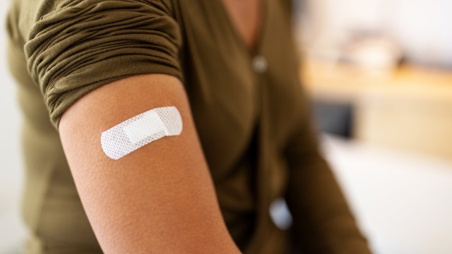 Article thumbnail: Bandage on arm of a female after taking vaccine. Close-up of a female patient with bandage on hand after taking injection.
